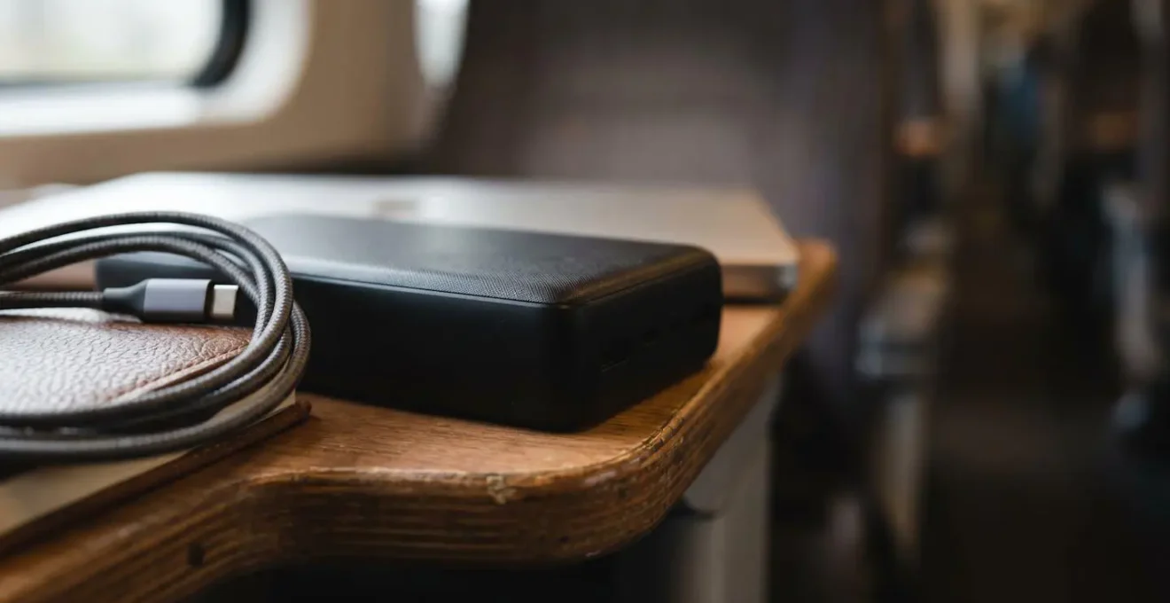 Macro detail view of professional commuter workspace essentials on train table