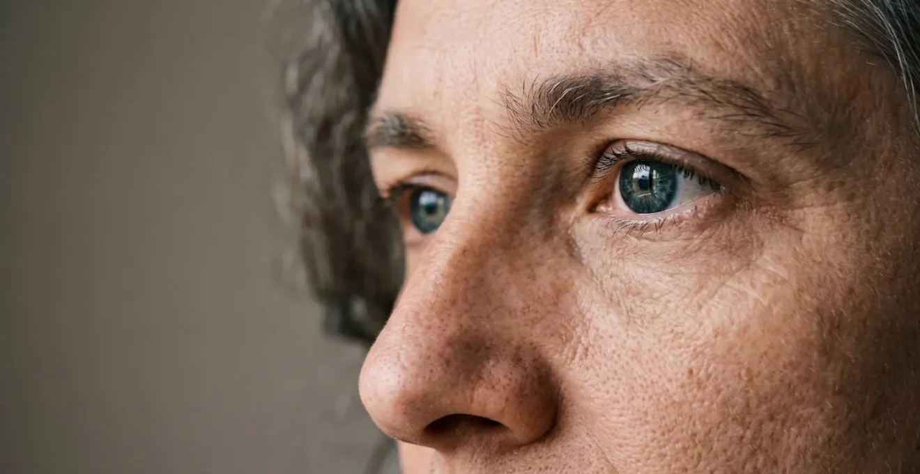 Close portrait showing natural skin texture detail versus artificial plastic-looking skin smoothing effect