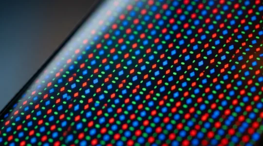Close-up detail of modern OLED smartphone display showing pristine screen quality with subtle pixel grid structure