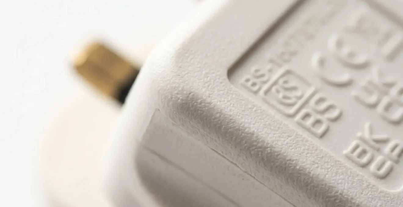 Extreme close-up detail of electrical safety markings and certification symbols on power equipment surface