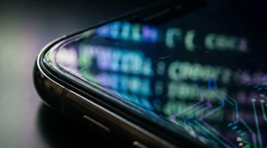 Close-up of smartphone security analysis showing abstract code patterns and digital security elements